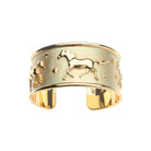 Gold ring with horse design on a white background