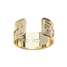 Gold ring with engraved text on a white background