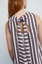 Striped sleeveless top with open back and knot detail on a plain background