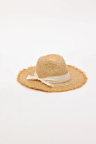 Straw hat with a white ribbon on a light gray background