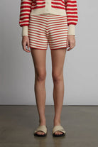 Person wearing a red and white striped outfit with a plain background