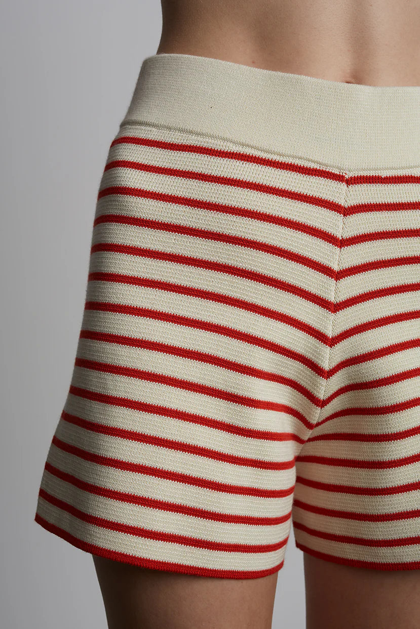 Close-up of red and white striped shorts on a plain background