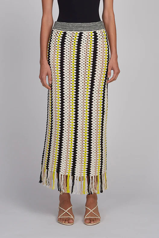 Woman wearing a patterned skirt with a plain background