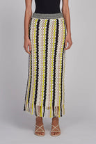 Woman wearing a patterned skirt with a plain background