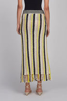Woman wearing a patterned skirt on a gray background