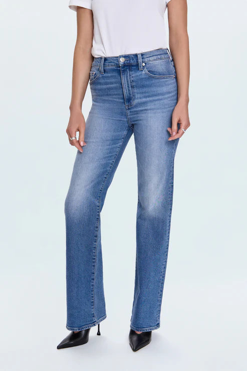 Person wearing light blue jeans on a white background