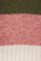 Close-up of a knitted textile with horizontal color blocks: dark olive green at the top, heathered dusty pink in the middle, and off-white at the bottom.