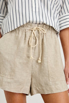 Beige shorts with a drawstring worn by a person on a plain background