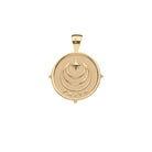 Gold pendant with 'FAITH' engraving on a white background
