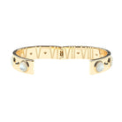 A gold-plated cuff bracelet featuring Roman numerals on the inside, a spring-ring clasp, and two oval white mother-of-pearl inlays on the outer sides, shown against a plain white background.