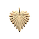 Gold pendant with a starburst design on a white background