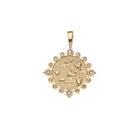 Gold pendant with intricate design and colorful stones on a white background