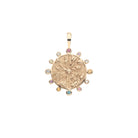 Gold pendant with gemstones on a white background