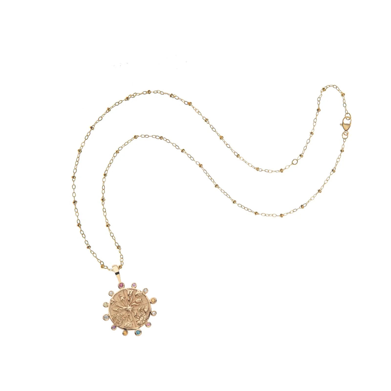 Gold necklace with a decorative pendant on a white background