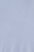 A close-up of a light blue fabric texture, likely a knit or jersey material.