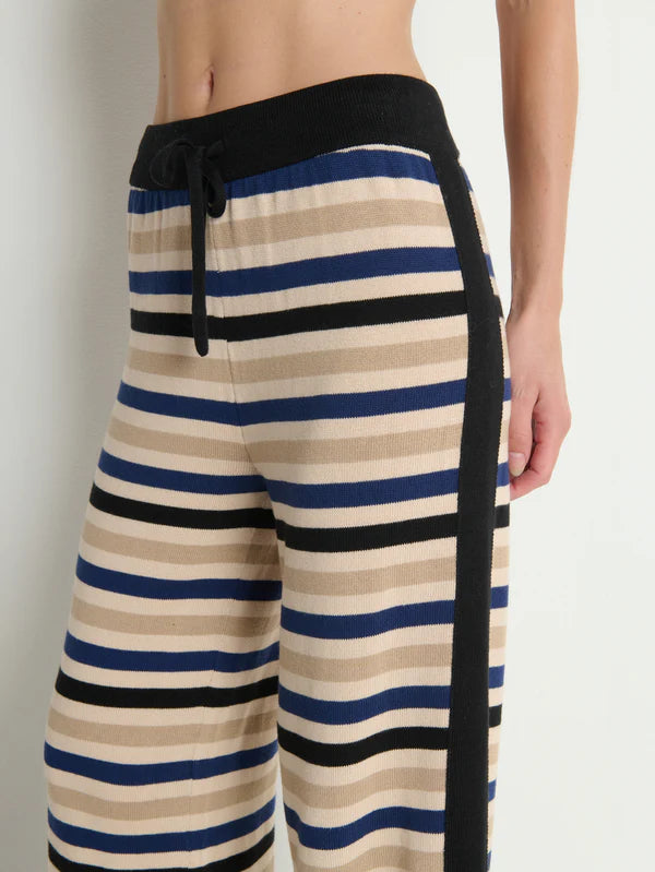 Striped pants with black drawstring on a plain background