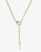 Gold necklace with a pendant featuring green and clear gemstones on a white background