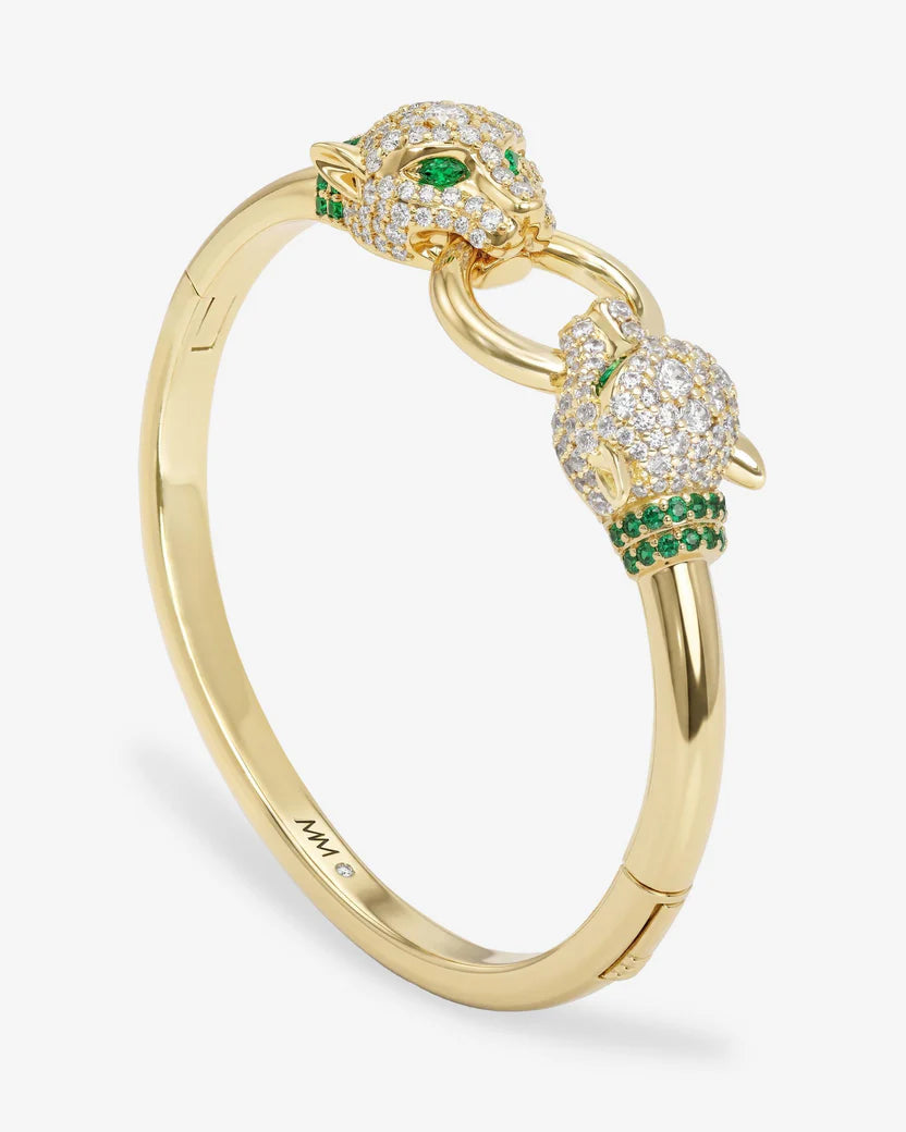 Gold bracelet with panther head designs and green gemstones on a white background