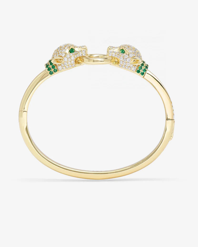 Gold bracelet with green gemstones on a white background