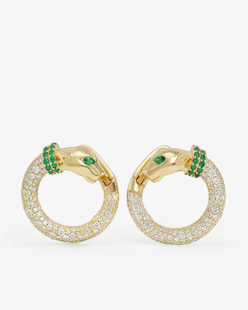 Gold hoop earrings with green gemstones on a white background