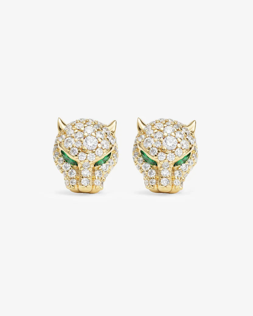 Gold panther-shaped earrings with green eyes on a white background