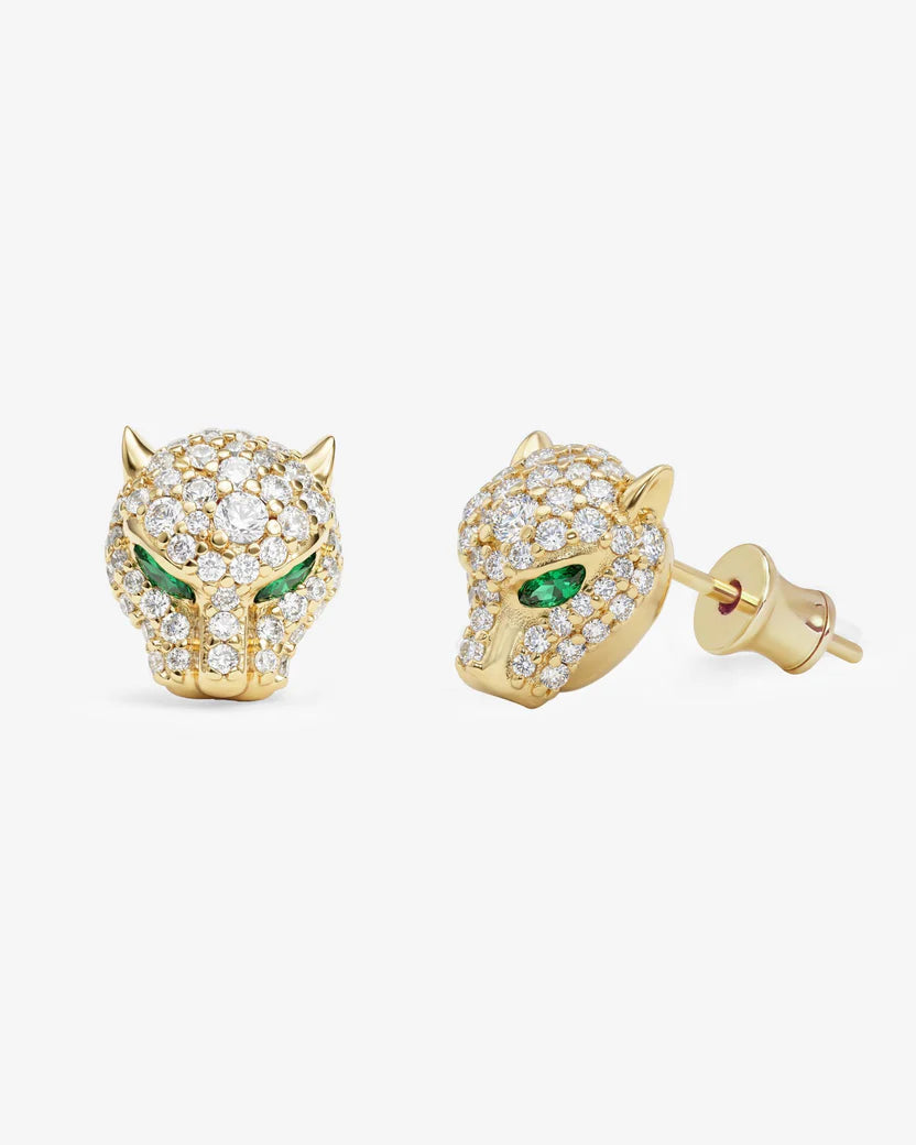 Gold panther-shaped earrings with green eyes on a white background
