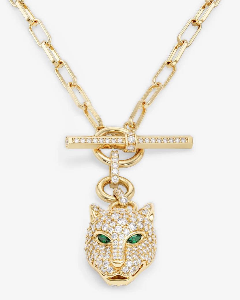 Gold necklace with a panther head pendant on a white background