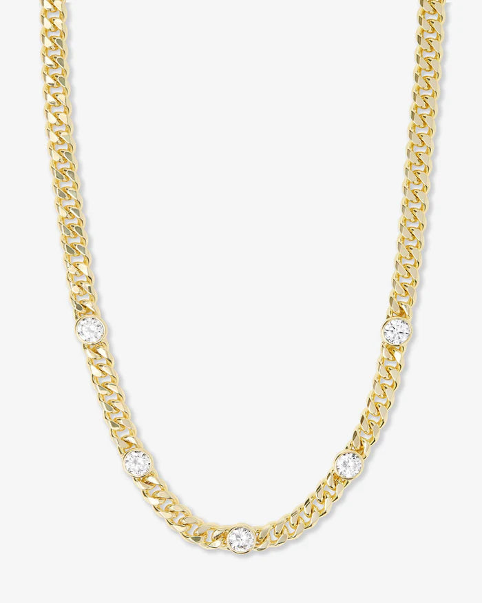 Gold chain necklace with diamond accents on a white background
