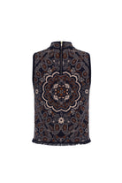 A sleeveless zip-front vest with a high mock neck, featuring an intricate navy blue, brown, and beige mandala pattern and fringed edges, shown against a plain white background.