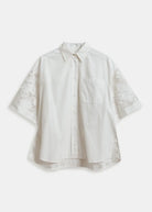 White blouse with lace sleeves on a white background