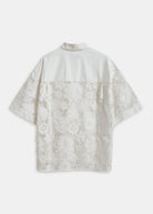 Back view of a white blouse with lace sleeves and back panel on a white background