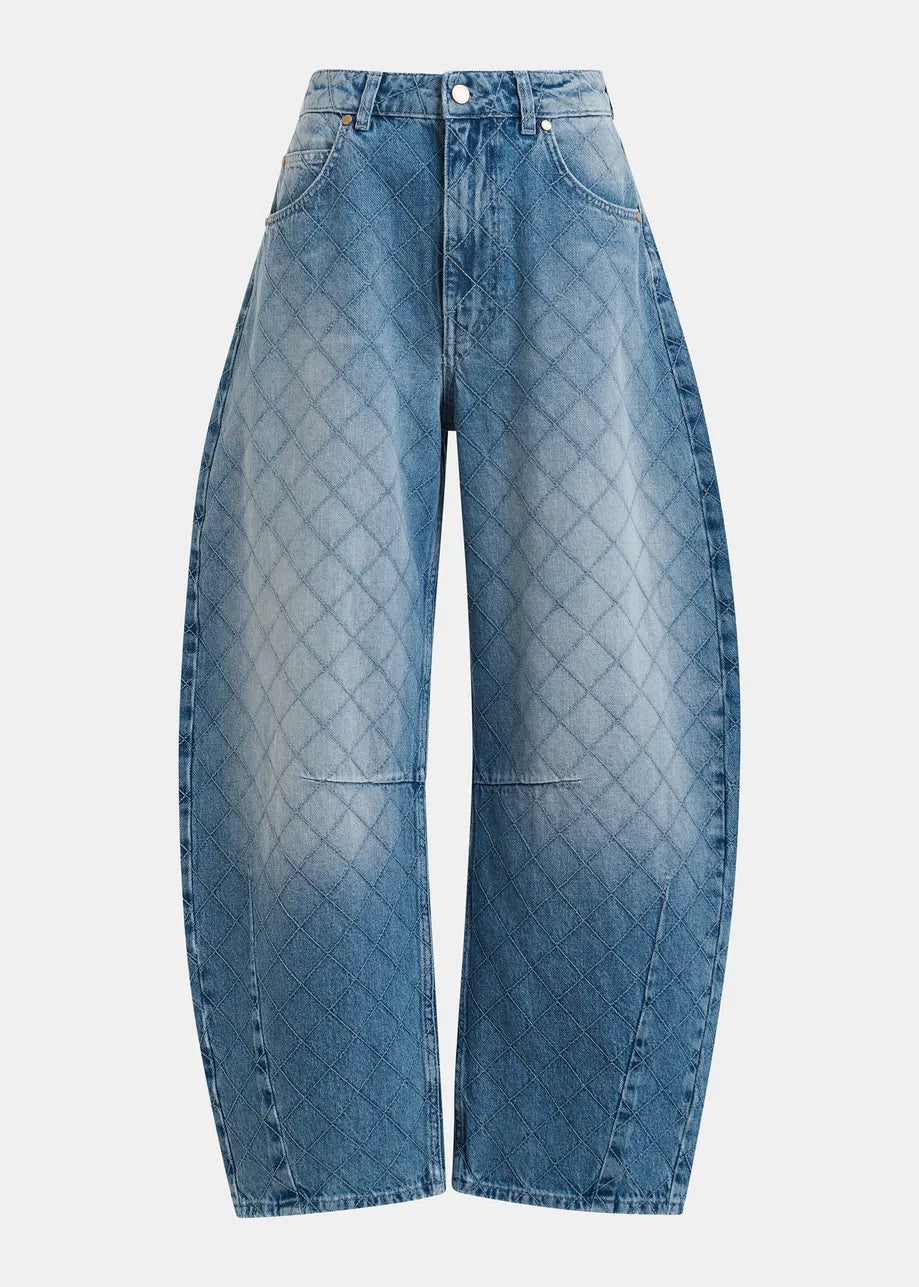 Blue diamond-quilted jeans on a light gray background