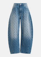 Blue diamond-quilted jeans on a light gray background