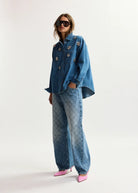 Person wearing a denim outfit with a white background