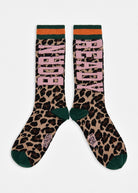 A pair of crew socks with a leopard print pattern, featuring the words 'BORN READY' in pink block letters, dark green heels and toes, and orange and dark green striped cuffs, shown against a plain light gray background.