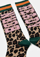 A pair of crew socks featuring a leopard print pattern, large pink 'BORN' text on one sock, and 'READY' on the other, with green and orange striped ribbed cuffs.