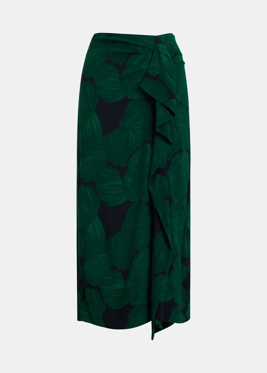 A dark green midi skirt with a tropical leaf print in dark green and black, featuring a ruffled wrap-style waist and side drape, shown against a light gray background.