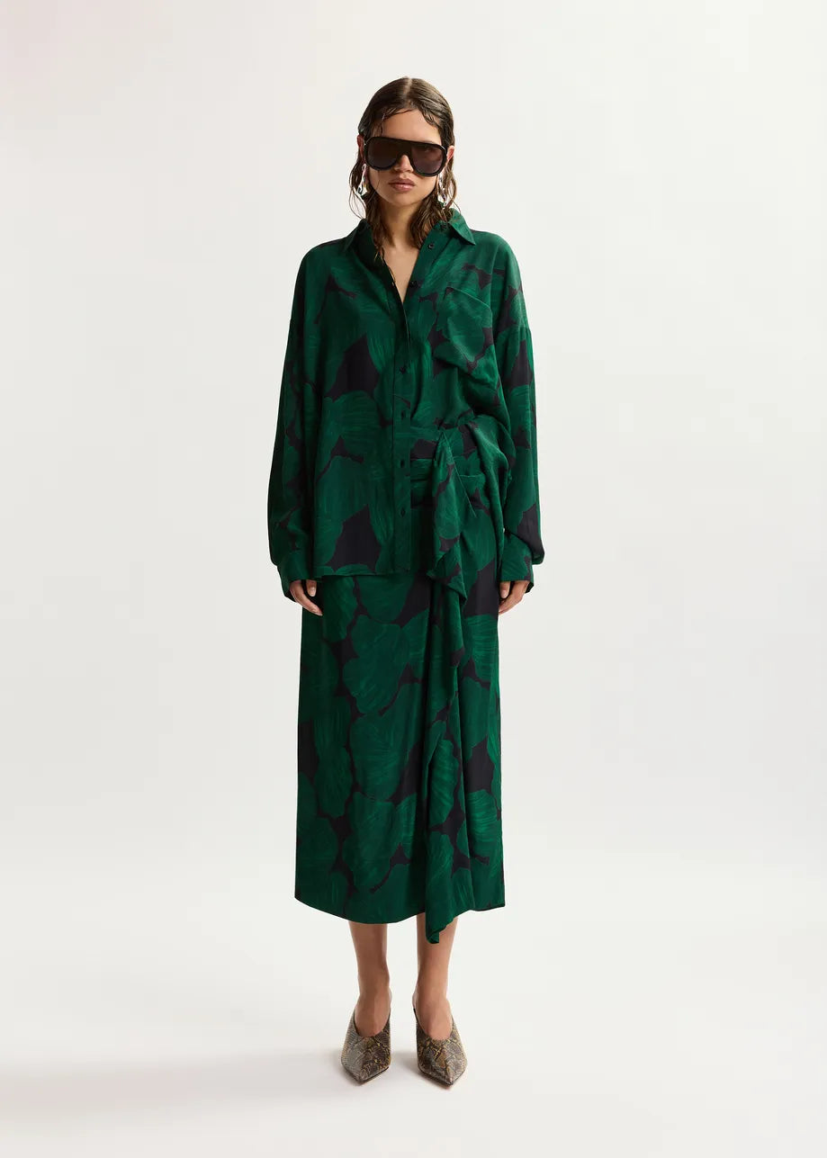Woman wearing a green patterned outfit on a white background