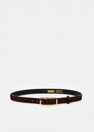 A dark brown leather belt with a gold buckle, displayed horizontally on a light gray background. The inner side of the belt is black with gold branding text that reads 'COSTUME D'EPICE'.