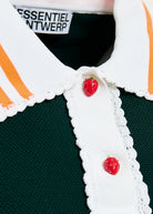 Close-up of a green polo shirt with orange stripes and red buttons, featuring the brand 'Essentiel Antwerp'.