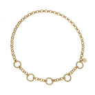 A gold chain necklace featuring alternating textured circular links and smaller oval links, displayed on a clean white background.