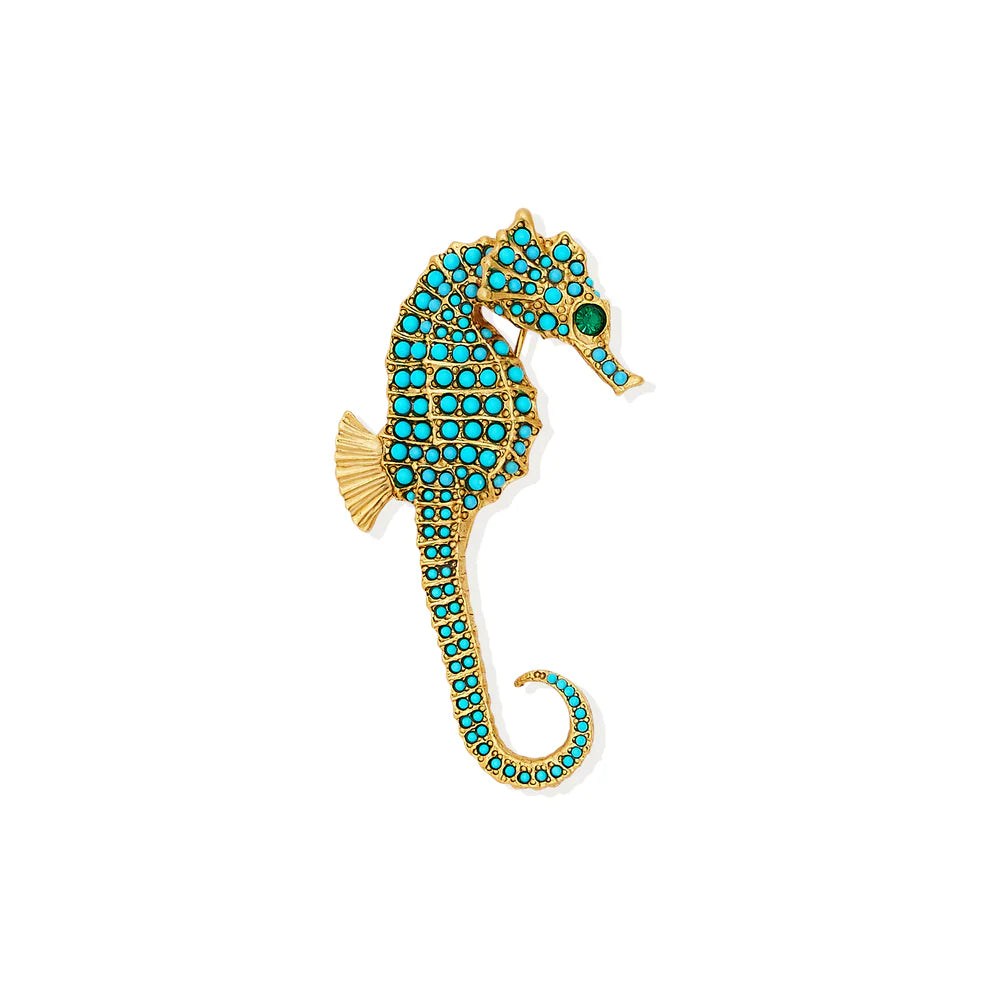 Gold seahorse brooch with turquoise stones on a white background