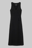 A black sleeveless wrap-style midi dress with a V-neckline and a self-tie waist, shown against a solid gray background.