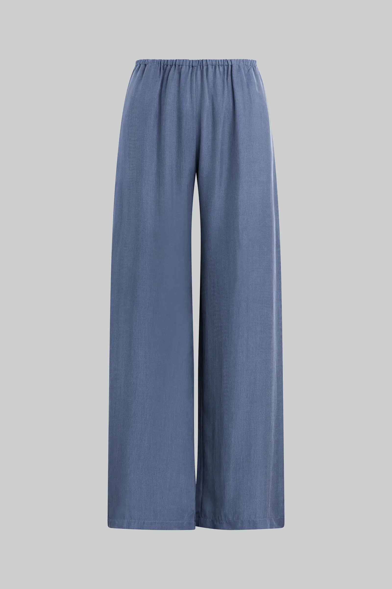 A pair of wide-leg trousers in a dusty slate blue color, shown against a solid light gray background.