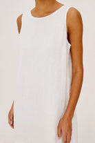 White sleeveless dress worn by a person on a plain background