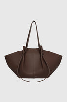 Brown leather handbag on a light gray background