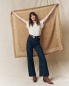woman holding a bandana with a fabric background