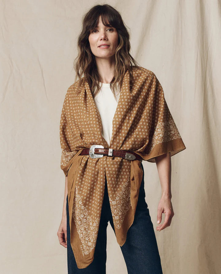 woman wearing a bandana with a belt with a fabric background