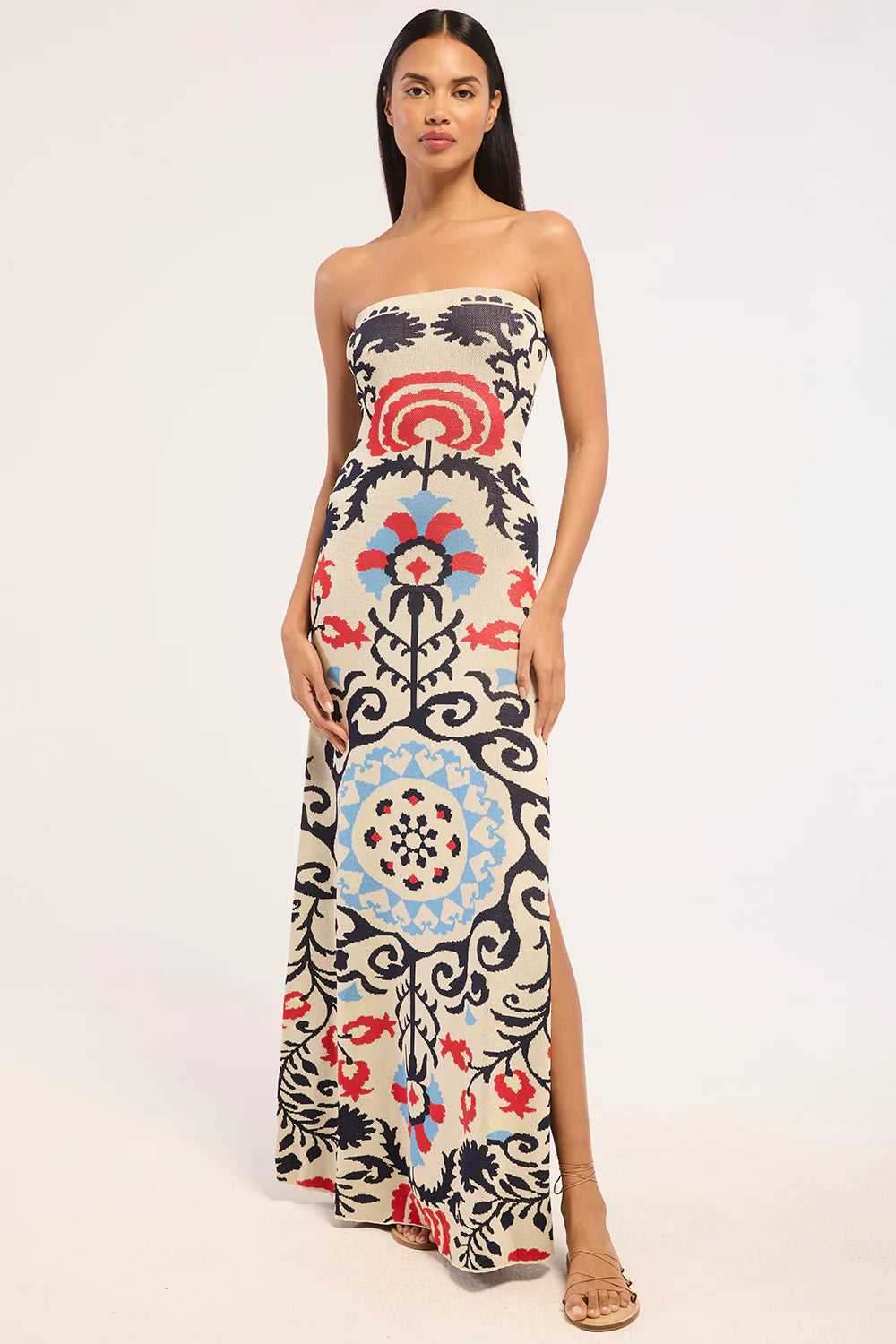 Woman wearing a strapless dress with a colorful floral pattern on a white background