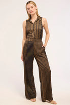Woman wearing a patterned jumpsuit on a white background